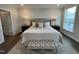 Bright bedroom with a queen-size bed and ample natural light at 11549 Helmond Way # 102, Raleigh, NC 27617