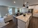 Open concept kitchen with island and dining area at 11549 Helmond Way # 102, Raleigh, NC 27617