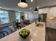 Open concept kitchen with island and seating at 11549 Helmond Way # 102, Raleigh, NC 27617
