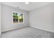 Simple bedroom with grey carpet and a large window at 9415 Bear Run Ln, Middlesex, NC 27557