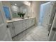 Double vanity bathroom with marble flooring and a large mirror at 324 Village Walk Dr, Clayton, NC 27527