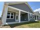 Gray house with a covered back porch and a grassy yard at 324 Village Walk Dr, Clayton, NC 27527