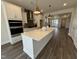 Open concept kitchen with island and view into living room at 324 Village Walk Dr, Clayton, NC 27527
