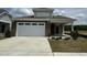 Brick home with a two-car garage and landscaping at 324 Village Walk Dr, Clayton, NC 27527