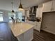 Modern kitchen with white cabinets, quartz countertops, and stainless steel appliances at 324 Village Walk Dr, Clayton, NC 27527