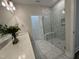 Double vanity bathroom with marble tile and walk in shower at 324 Village Walk Dr, Clayton, NC 27527