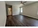 Spacious bedroom with dark wood-look flooring and ceiling fan at 324 Village Walk Dr, Clayton, NC 27527