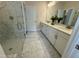 Double vanity bathroom with marble tile and walk in shower at 324 Village Walk Dr, Clayton, NC 27527