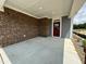 Covered front porch with brick exterior at 324 Village Walk Dr, Clayton, NC 27527