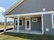 Gray house with a covered back porch and a grassy yard at 324 Village Walk Dr, Clayton, NC 27527