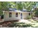 Charming ranch home with light beige siding and a lush green lawn at 208 Scarlett Dr, Chapel Hill, NC 27517