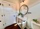 Stylish bathroom with white vanity, round mirror, and wood floor at 3701 Greystone Dr, Rocky Mount, NC 27804