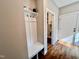 Inviting entryway with built-in bench, hooks, and access to laundry area at 3701 Greystone Dr, Rocky Mount, NC 27804