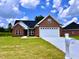Brick house with a two-car garage and well-maintained lawn at 3701 Greystone Dr, Rocky Mount, NC 27804