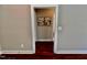 View down hallway with hardwood floors and artwork at 3701 Greystone Dr, Rocky Mount, NC 27804