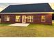 Brick house exterior with a large backyard and attached garage at 3701 Greystone Dr, Rocky Mount, NC 27804