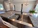 Modern kitchen features a farmhouse sink, granite countertops, and stainless steel appliances at 3701 Greystone Dr, Rocky Mount, NC 27804