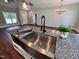 Kitchen island with farmhouse sink, granite countertop, and microwave at 3701 Greystone Dr, Rocky Mount, NC 27804