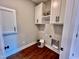 Bright laundry room, built-in shelving, and hardwood floor at 3701 Greystone Dr, Rocky Mount, NC 27804