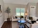 Bright living room with hardwood floors, comfortable sofas, and large windows at 3701 Greystone Dr, Rocky Mount, NC 27804
