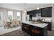 Modern kitchen with island, stainless steel appliances, and dining area at 1218 Helms St, Durham, NC 27713