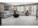 Finished basement with gray sectional sofa and fireplace at 1222 Helms St, Durham, NC 27713