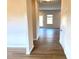 Light and bright entryway with hardwood floors leading to living area at 116 Bristow Ct # 49, Four Oaks, NC 27524