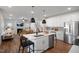 Open concept kitchen flows into living room with a fireplace and hardwood floors at 98 Claude Creek Dr, Smithfield, NC 27577