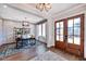 Bright entryway with hardwood floors, built-in shelving, and French doors at 2865 Silk Hope Gum Springs Rd, Pittsboro, NC 27312