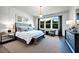 Spacious main bedroom with large windows and sitting area at 2865 Silk Hope Gum Springs Rd, Pittsboro, NC 27312