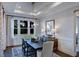 Bright dining room with large windows and elegant chandelier at 2865 Silk Hope Gum Springs Rd, Pittsboro, NC 27312