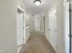 Upstairs hallway with carpet and multiple doors at 177 Genoa Ln, Clayton, NC 27527