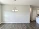 Empty dining room with hardwood floors and a chandelier at 160 Emerson Fields Dr, Pikeville, NC 27863