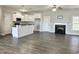 Living room with hardwood floors, fireplace, and kitchen island at 160 Emerson Fields Dr, Pikeville, NC 27863