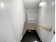 Basement stairs with wooden railing at 4808 Connell Dr, Raleigh, NC 27612