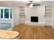 Living room with white brick fireplace and hardwood floors at 4808 Connell Dr, Raleigh, NC 27612