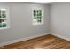Bright bedroom with hardwood floors and large windows at 4808 Connell Dr, Raleigh, NC 27612