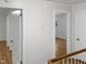 Hallway with doors to bedrooms and hardwood floors at 4808 Connell Dr, Raleigh, NC 27612