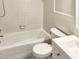 Clean bathroom with white tile and a bathtub at 4808 Connell Dr, Raleigh, NC 27612