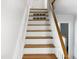 Clean and modern staircase with wooden steps and white railings at 4808 Connell Dr, Raleigh, NC 27612