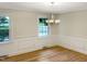 Formal dining room with hardwood floors and a chandelier at 4808 Connell Dr, Raleigh, NC 27612