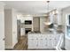 Modern kitchen featuring white cabinets, granite counters, and stainless steel appliances at 4808 Connell Dr, Raleigh, NC 27612