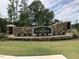 Stone entrance sign for the Ellsworth community with landscaping and lighting at 107 Ludbrook Ct, Apex, NC 27523