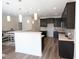 Modern kitchen with dark cabinetry, island, and stainless steel appliances at 1055 Talisker Way # 19, Burlington, NC 27215