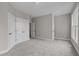 Spacious bedroom with grey carpet and double door closet at 815 Brewer Ave, Wake Forest, NC 27587