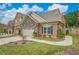 Brick front exterior with two-car garage and landscaping at 1061 Talisker Way # 20, Burlington, NC 27215