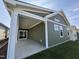 Covered back porch with grey siding and a sliding glass door at 146 Swain St, Clayton, NC 27527