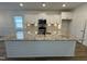 Kitchen features a large island with granite countertops and white cabinets at 146 Swain St, Clayton, NC 27527
