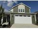Two story green house with white garage door at 146 Swain St, Clayton, NC 27527