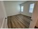 Bright bedroom with hardwood flooring and two windows with blinds at 146 Swain St, Clayton, NC 27527